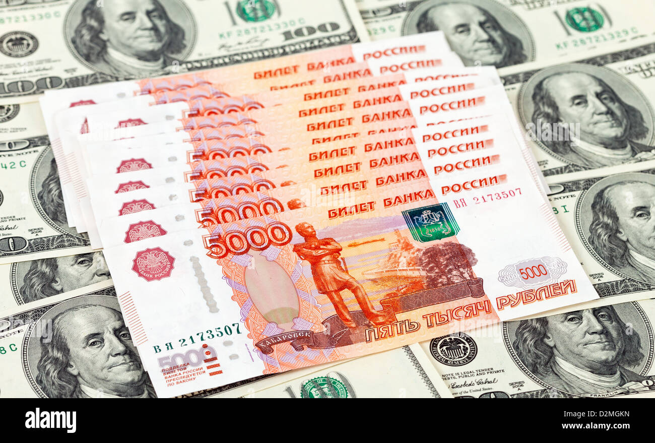 Russia Roubes Russian roubles bills laying over dollars background Stock Photo - Alamy