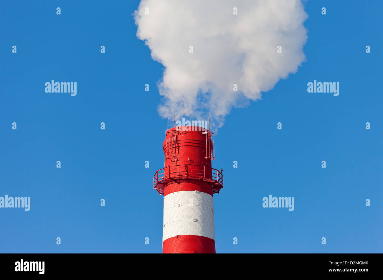 Industrial chimney with smoke over blue sky Stock Photo - Alamy