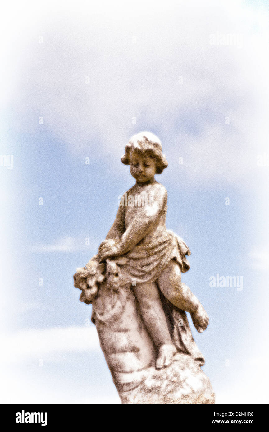A stone statue of a young girl in a cemetery. Christchurch, Canterbury, South Island, New Zealand. Stock Photo