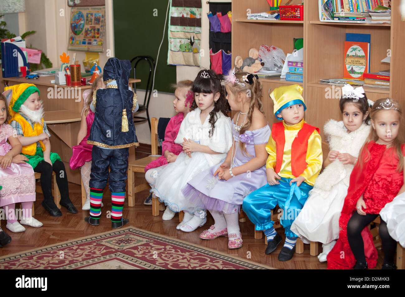 Reportage photos from Russian children kindergarten. Kids and parents in New Year eve celebration. Playing happy boys and girls. Stock Photo