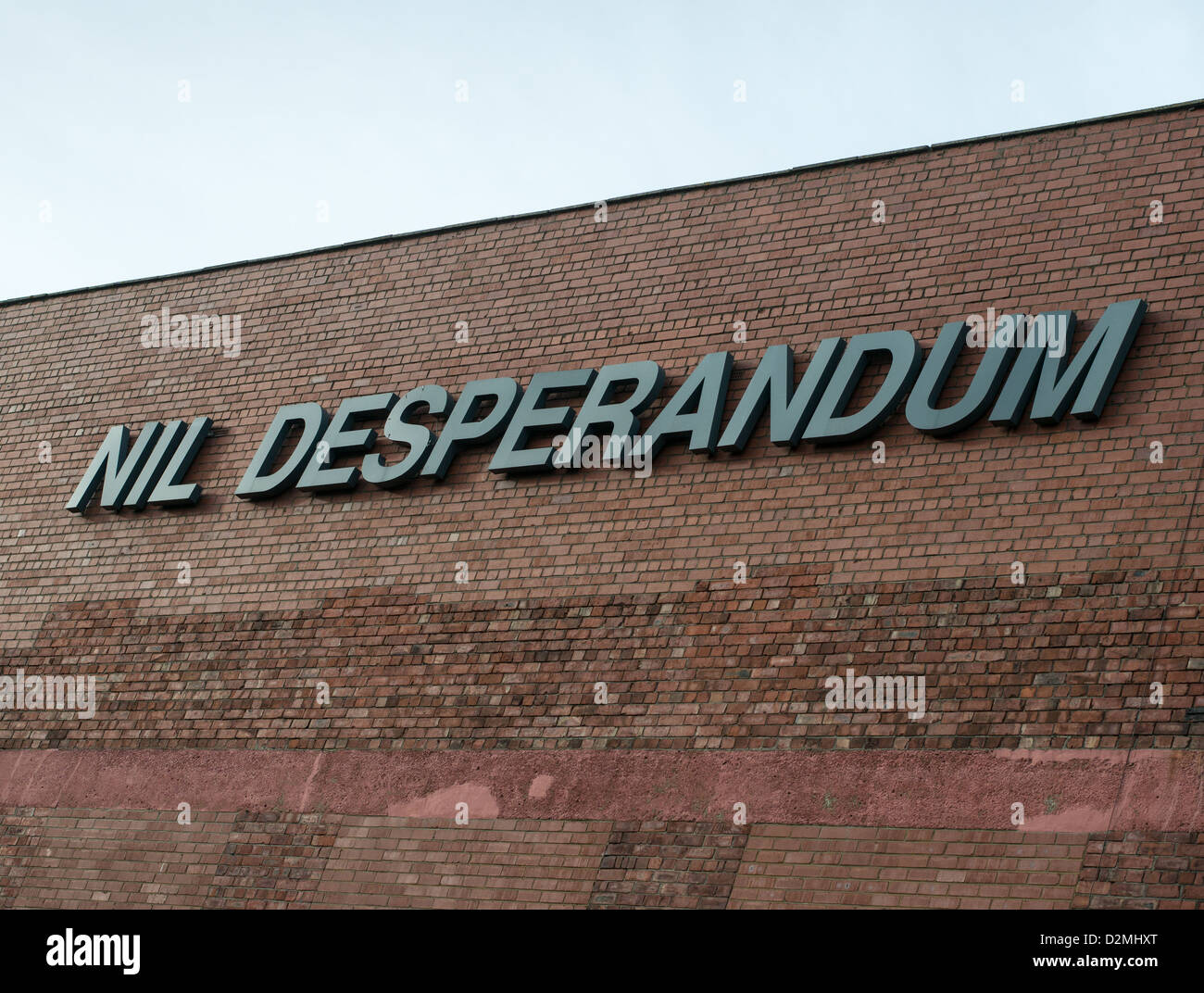Nil Desperandum appearing on the side of a brick built building Sunderland, north east England UK Stock Photo
