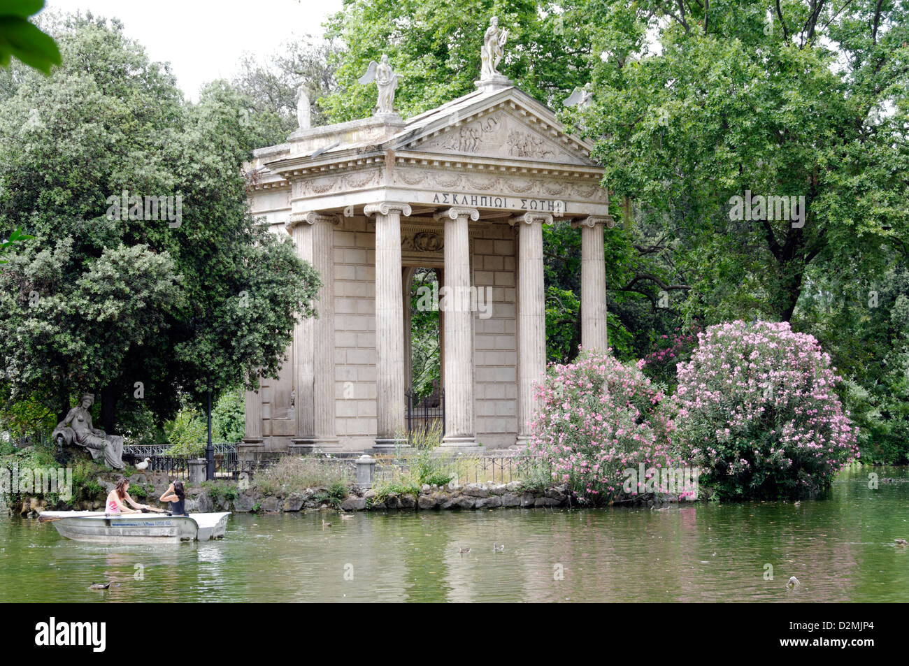 Rome. Italy. People in boats rowing around the Ionic Temple of