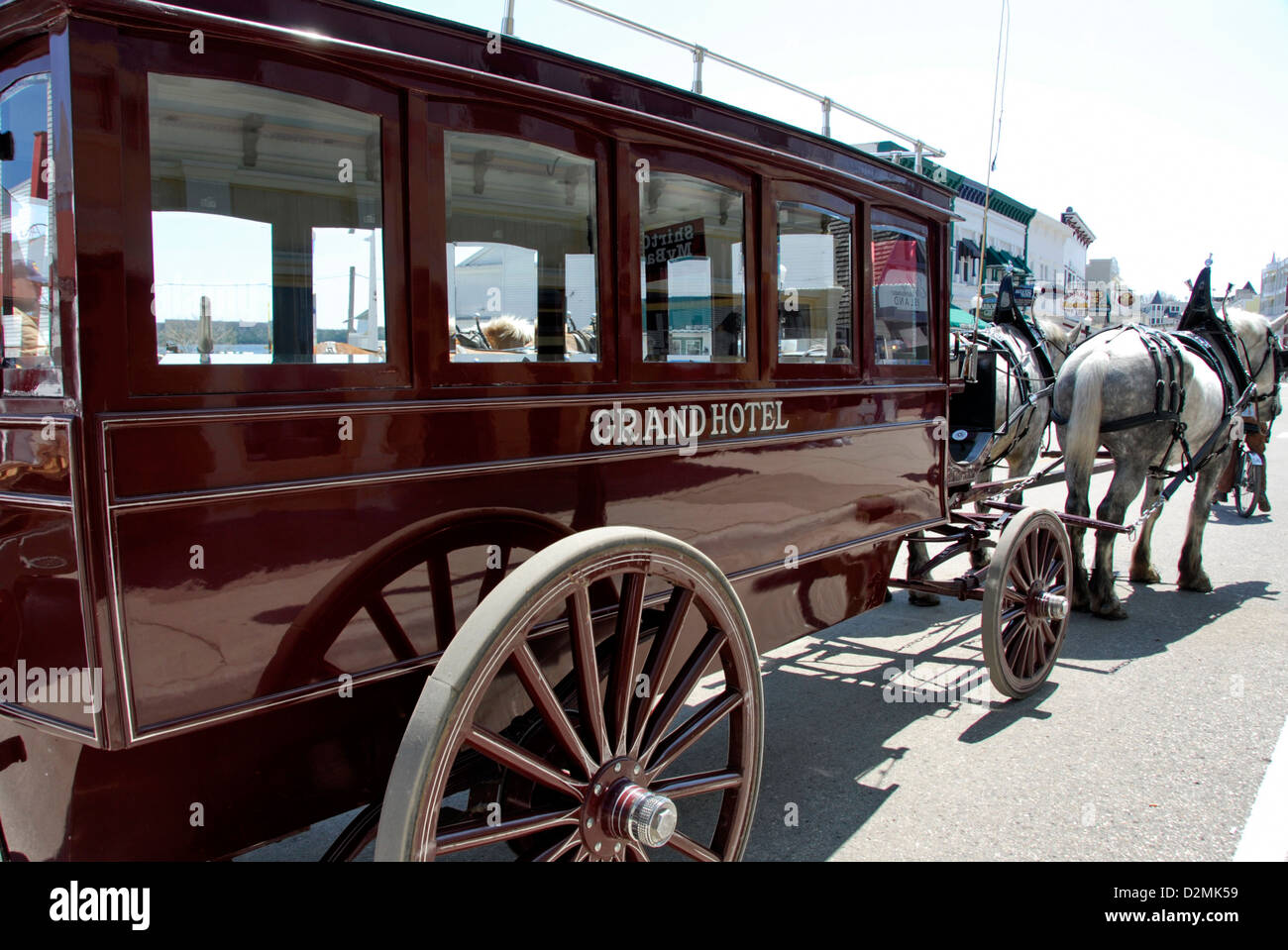 Horse-drawn carriage from Grand Hotel at pier on Mackinac Island,  Lake Huron, Michigan, USA Stock Photo