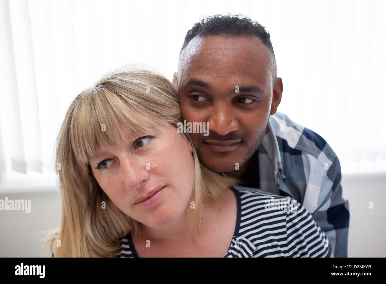 white female black male close heads thoughtful expressions Stock Photo