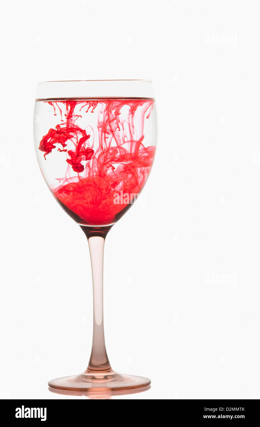 Red color streaks with water in a wine glass Stock Photo Alamy