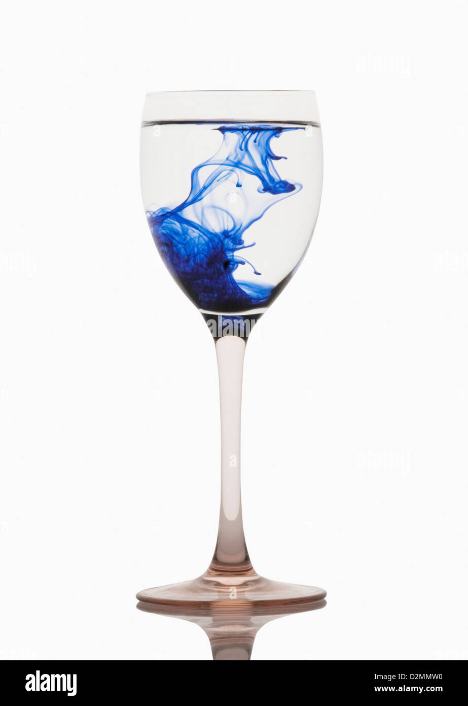 Blue color streaks with water in a wine glass Stock Photo Alamy