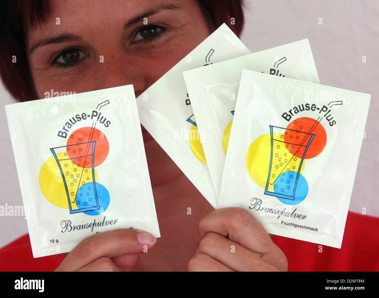 Kerstin Ranke shows bags of sherbet powder 'Brause-Plus' in Leipzig, Germany, 02 May 2008. About one and a half years ago, she had the ida of reinventing the sherbet powder of the GDR. After experimenting in her own kitchen with recipes and the help of food laboratories, she now introduced the powder with fruit taste in packages of 4x10 grams as a Ostalgie product. 'Ostalgie' is a term describing a special kind of nostalgia of Eastern Germans for the everyday life in the former GDR. Ranke is the owner of a shop of East German products and hopes that people want to reminisce the taste of the sh Stock Photo