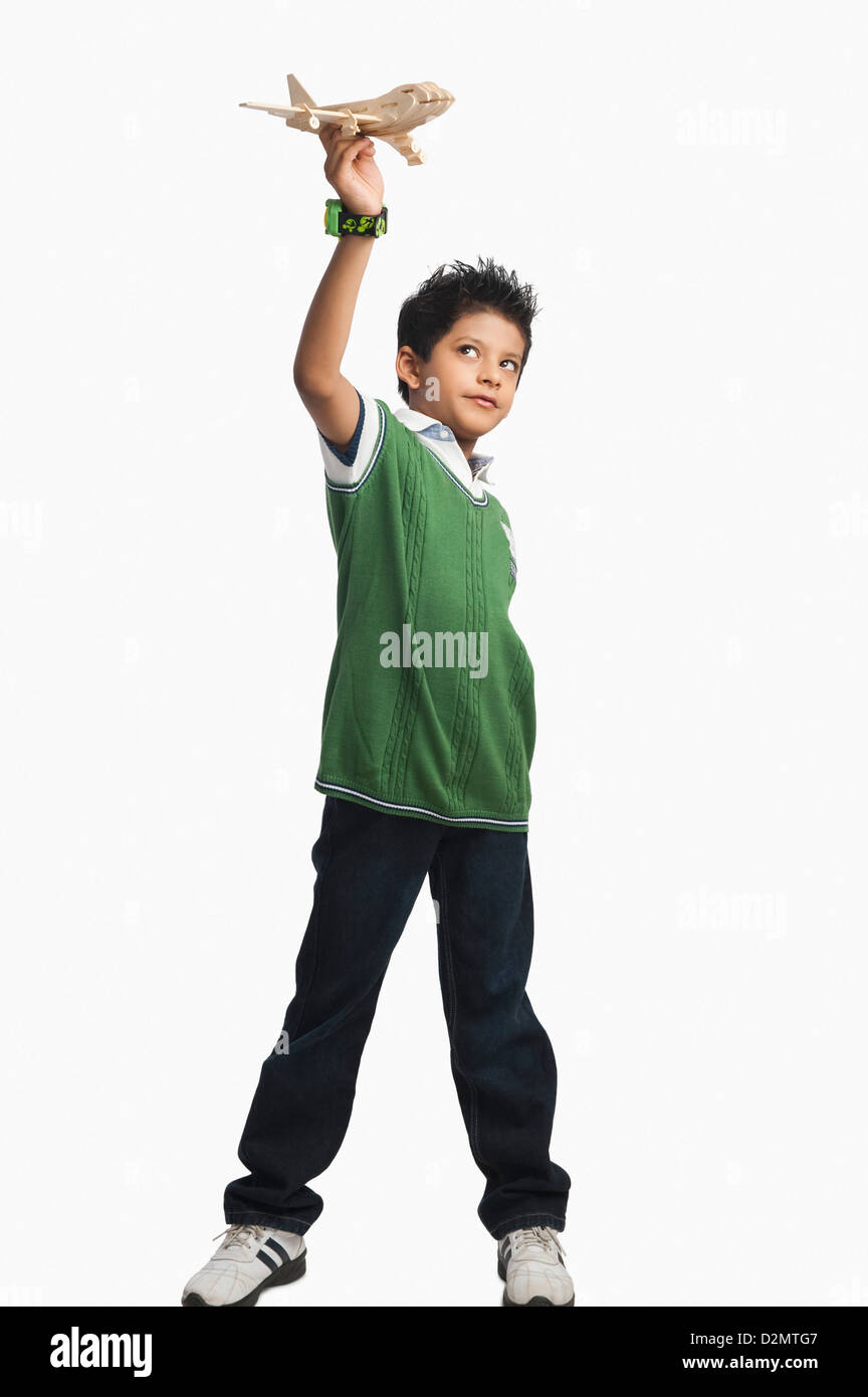 Boy playing with a toy airplane Stock Photo - Alamy