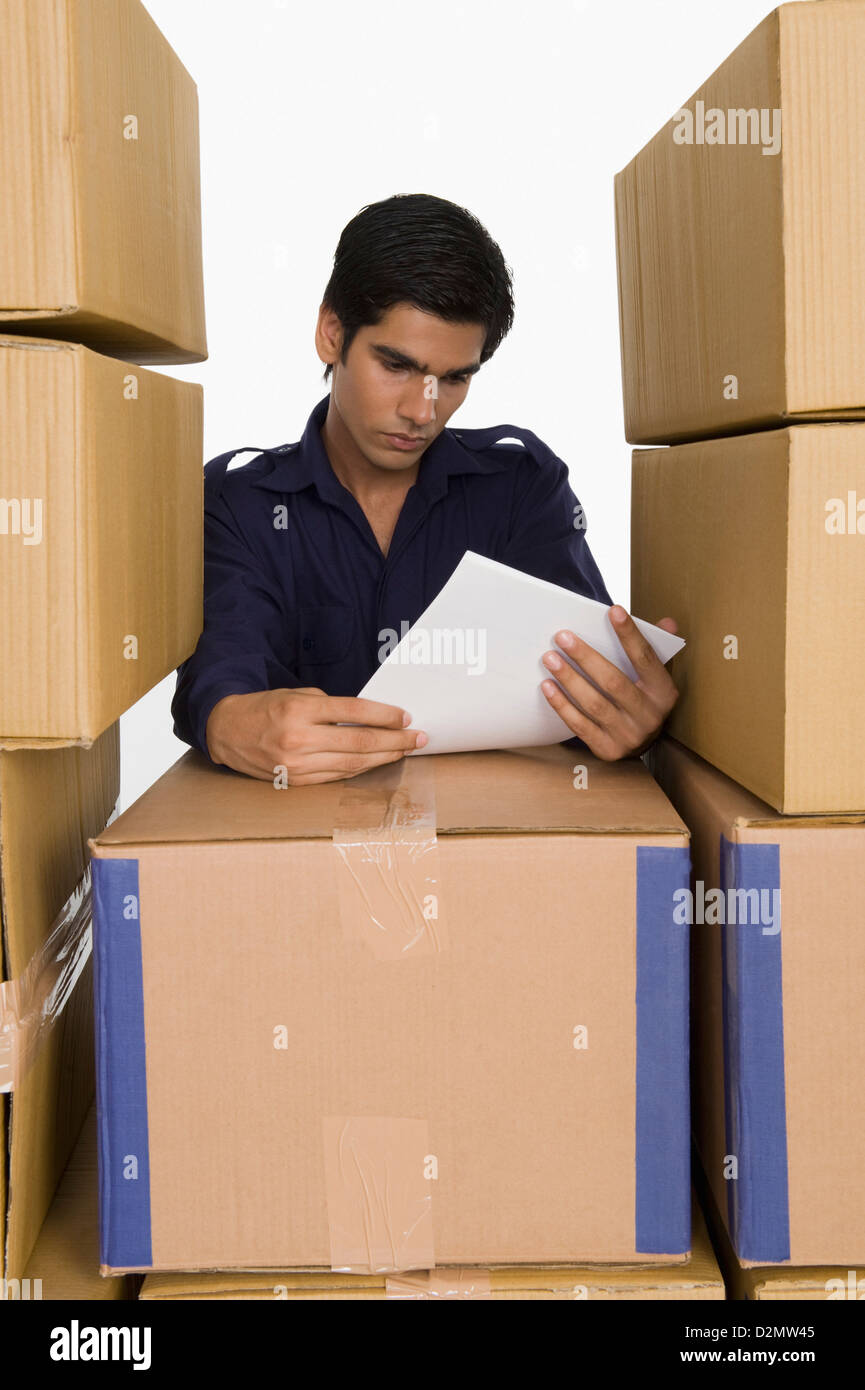 Store incharge reading papers with cardboard boxes Stock Photo Alamy