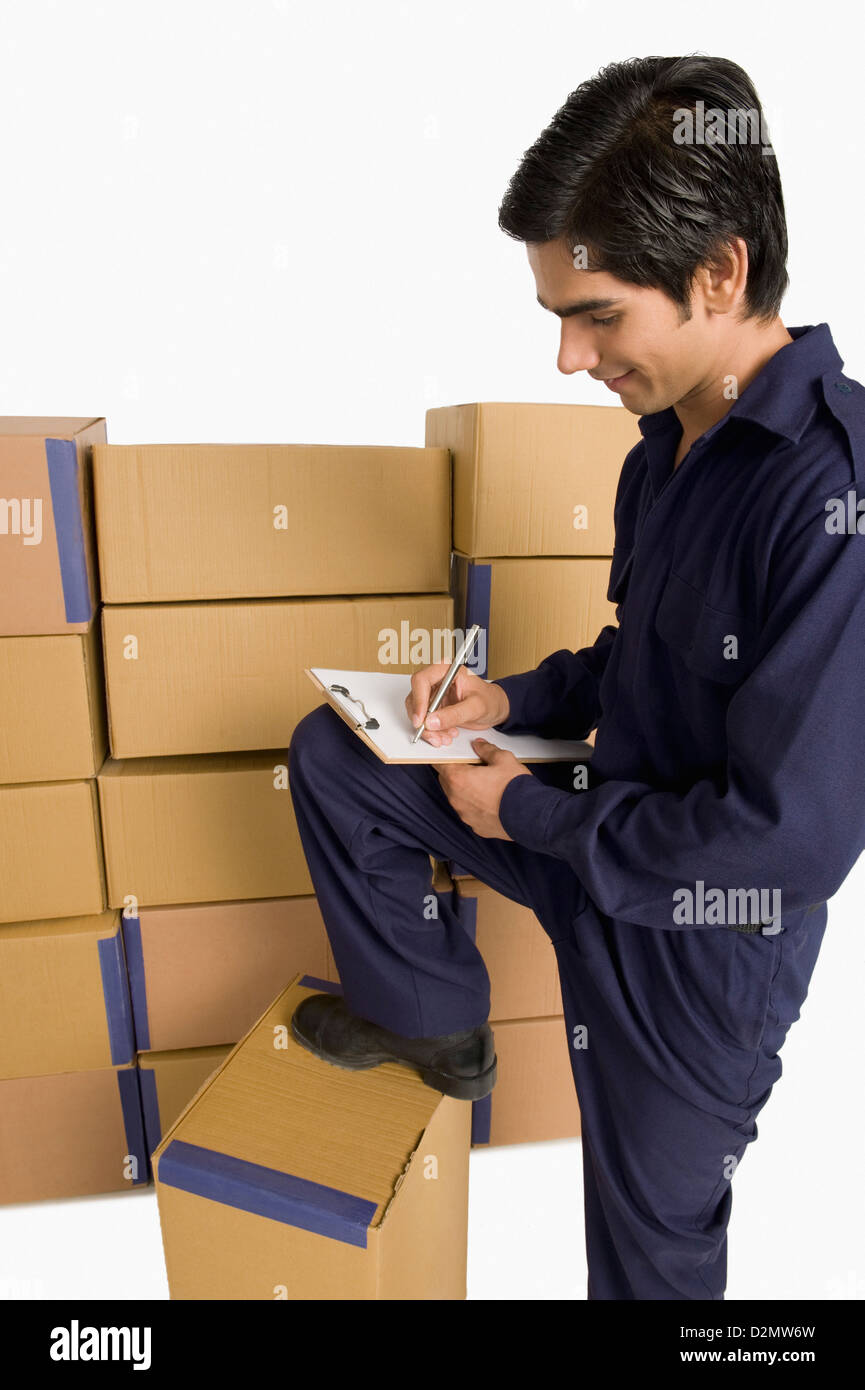 Store incharge counting cardboard boxes Stock Photo - Alamy