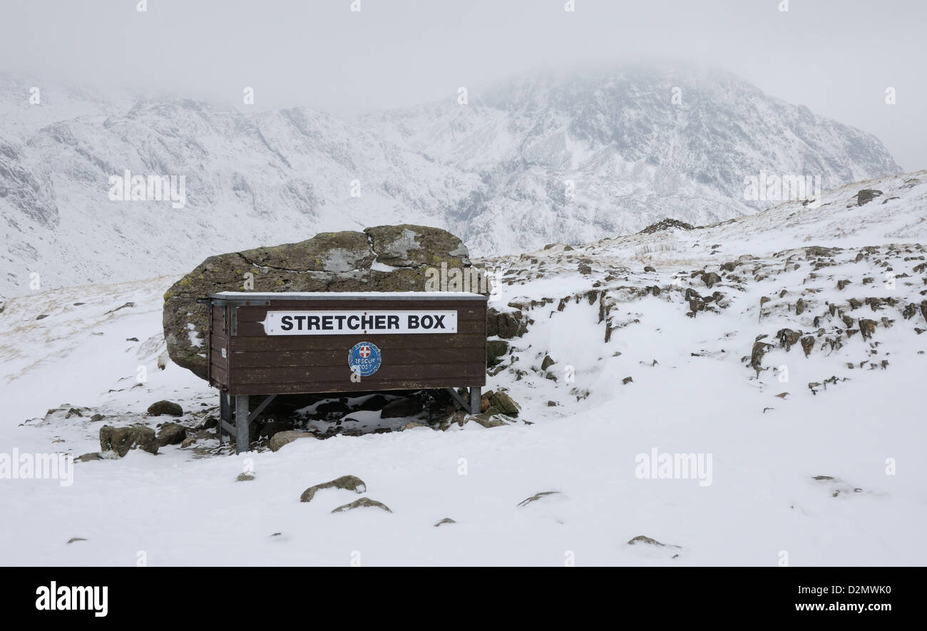 Mountain rescue stretcher box at Styhead in winter in the English Lake District. Lingmell in the background Stock Photo