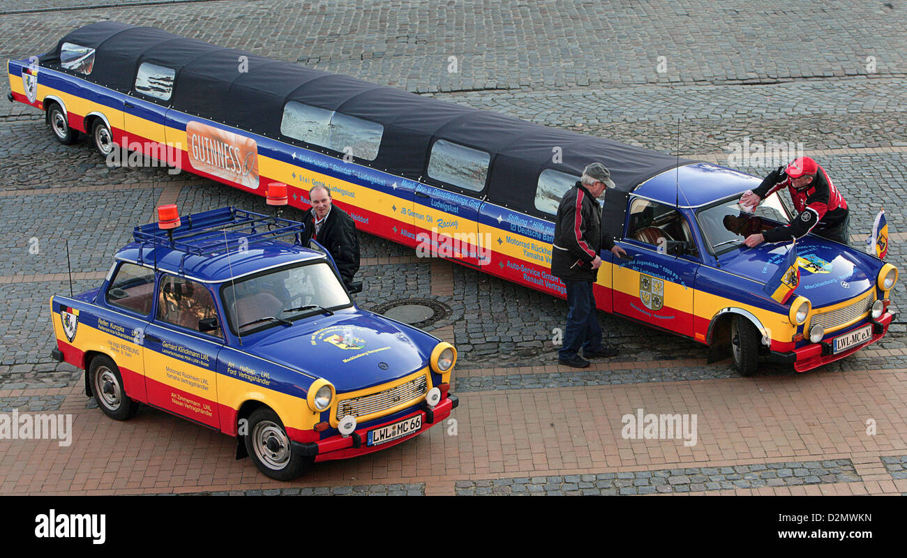 Member of the motor club clean the longest Trabant in the world, measuring 13,11 meters in length, in front of the city hall of Ludwigslust, Germany, 22 January 2008. The vehicle in the colors of the German state of Mecklenburg-Western Pommerania was built by members of the 'Fan- und Jugendclub 1000 PS' (Fan and Youth Club 1000 HP) in 1999 from ten disassembled Trabants and got an entry in the Guinness Book of World Records in 2000. In the fully functioning Trabant convertible 15 adults can be seated and the car can speed up to 25 km/h. The xxl Trabant is used for weddings, advertisement and f Stock Photo
