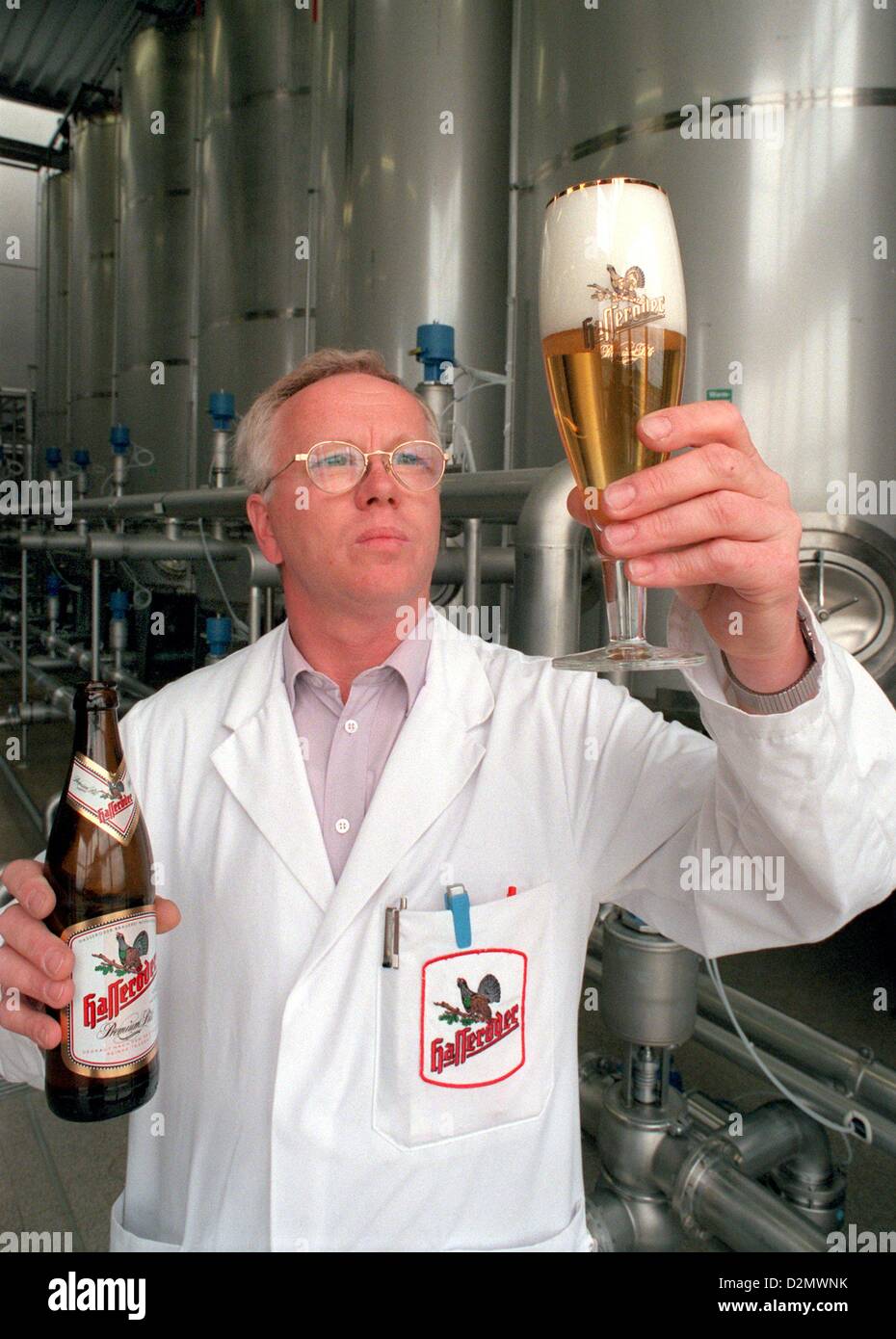Engineer Wilhelm Koch examines the quality of Hasseröder beer with his eyes and his tongue at Hasseröder Brauerei in Wernigerode, Germany, 09 December 2002. Photo: Hubert Link Stock Photo