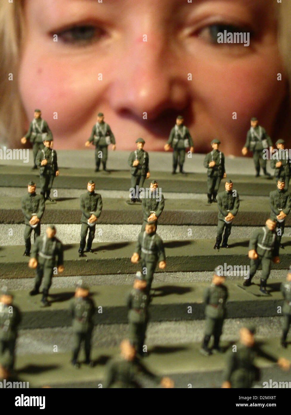 Tin figure painter Angelika Hauser looks at miniature NVA soldiers (National People's Army of the GDR) of the scale 1:87 at the scale model company Ritter C.B. von Krauthauser in Waltersdorf, Germany, 17 January 2005. The miniature models are around the size of a two-cents-coin. The company specialized on models of the First and Second World War, as well was GDR vehicles. The ideas come from what one can find on decaying industrial sites, museums and old photographs. There are around 200 dealers and 100 collectors in Germany, Austria, Switzerland and the US ordering the products of the company Stock Photo