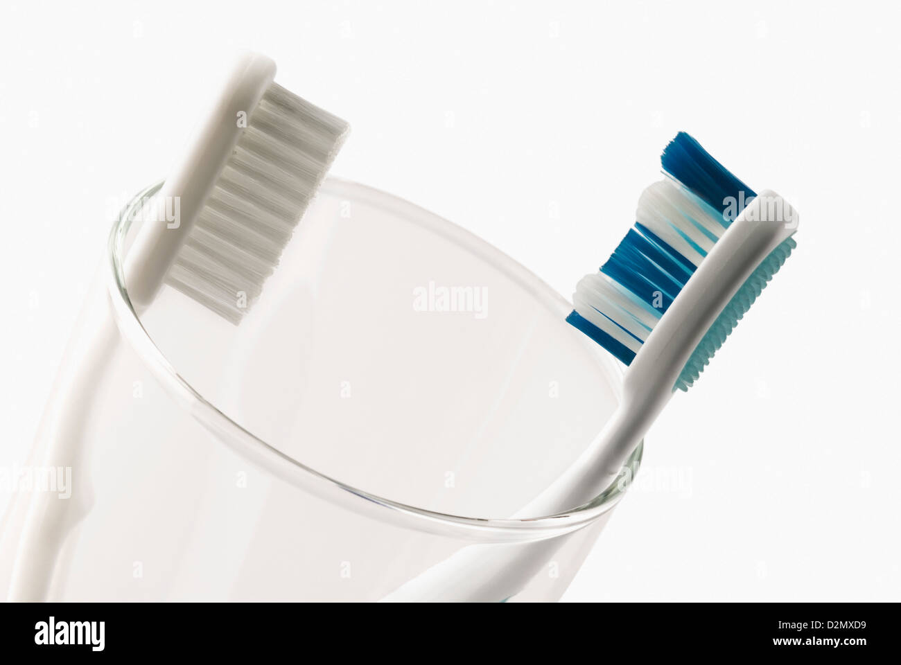 Two toothbrushes in a glass Stock Photo - Alamy