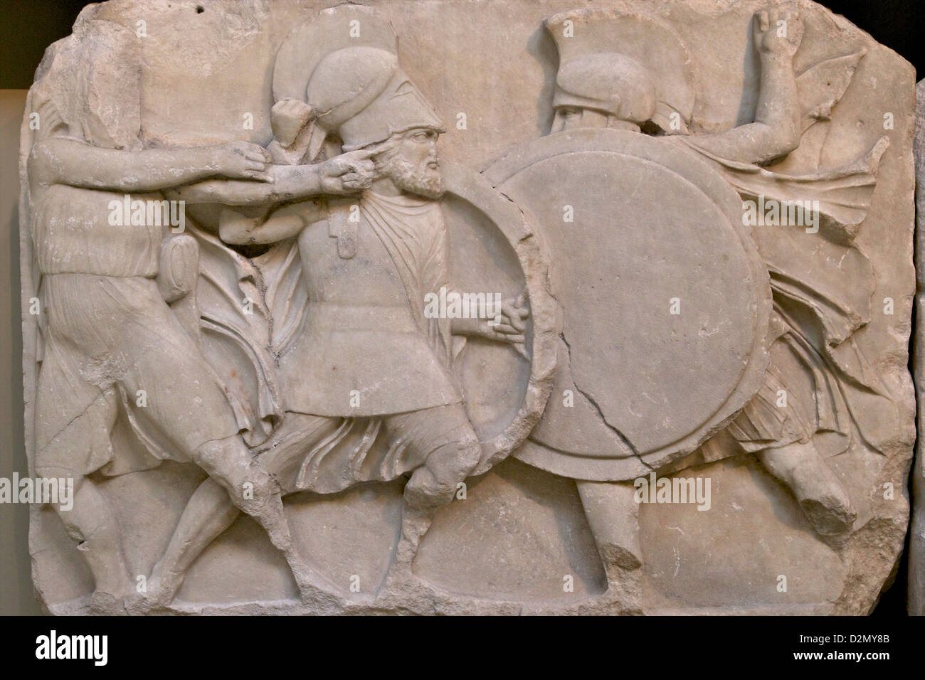 Two warriors clash shields and archer draws bow, Large Podium frieze, Nereid Monument, British Museum, London, England, UK, GB, Stock Photo
