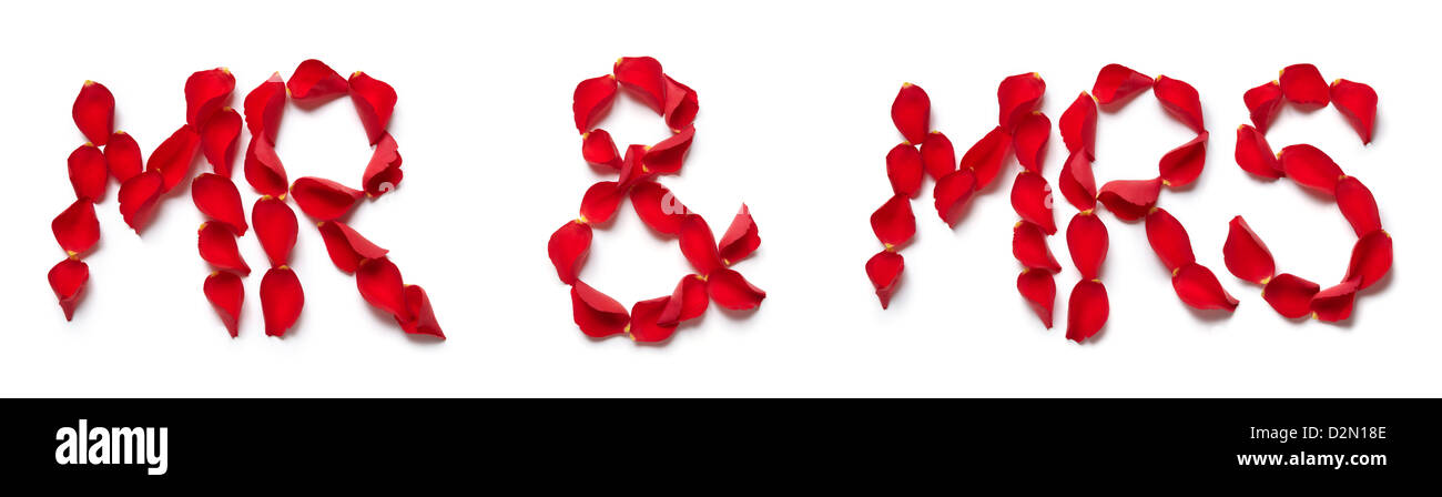 Red rose petals spelling mr and mrs on white background Stock Photo