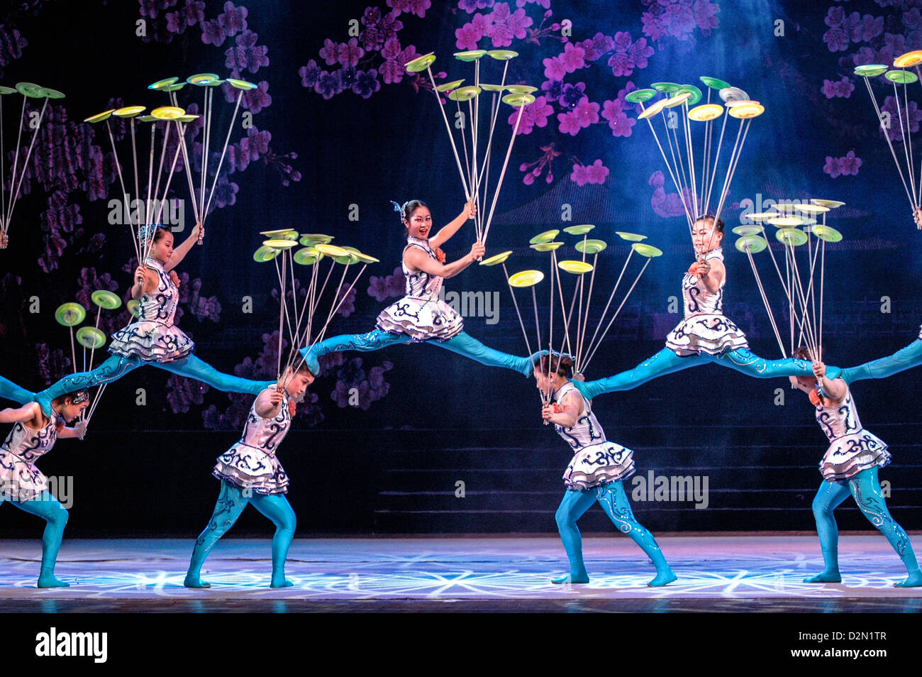 Acrobats perform splits whilst spinning plates Stock Photo - Alamy