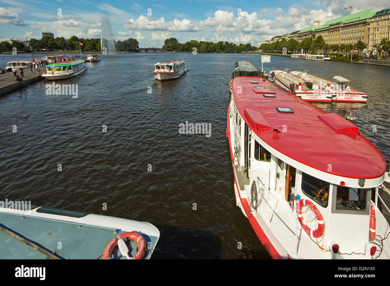 Tour boats that ply the popular Alster Lake moored at the Jungfernstieg with the Ballindamm beyond, Hamburg, Germany, Europe Stock Photo