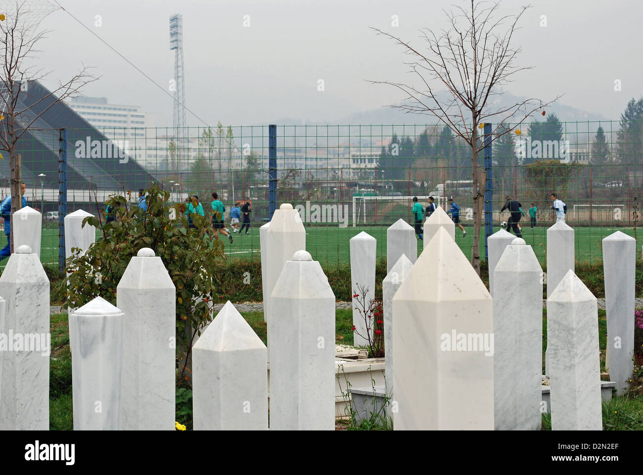 The graves of those who died during the siege of Sarajevo buried in Koševo cemetery next to football stadium and sports complex. Stock Photo