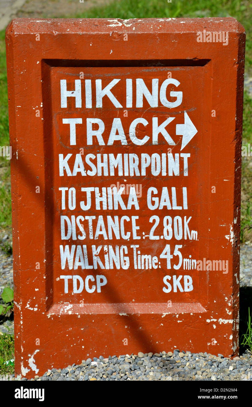 Sign showing time and distance of hiking track to Kashmir Point from a location near Mall Road in Murree, Pakistan. Stock Photo