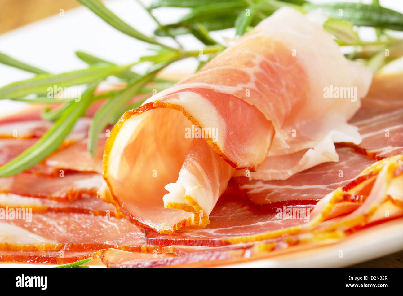 Delicious drycured ham sliced paper thin Stock Photo Alamy