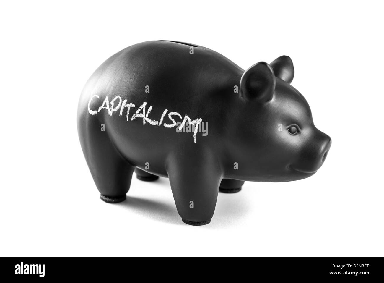 Black piggy bank on white background with 'capitalism' written on it Stock Photo