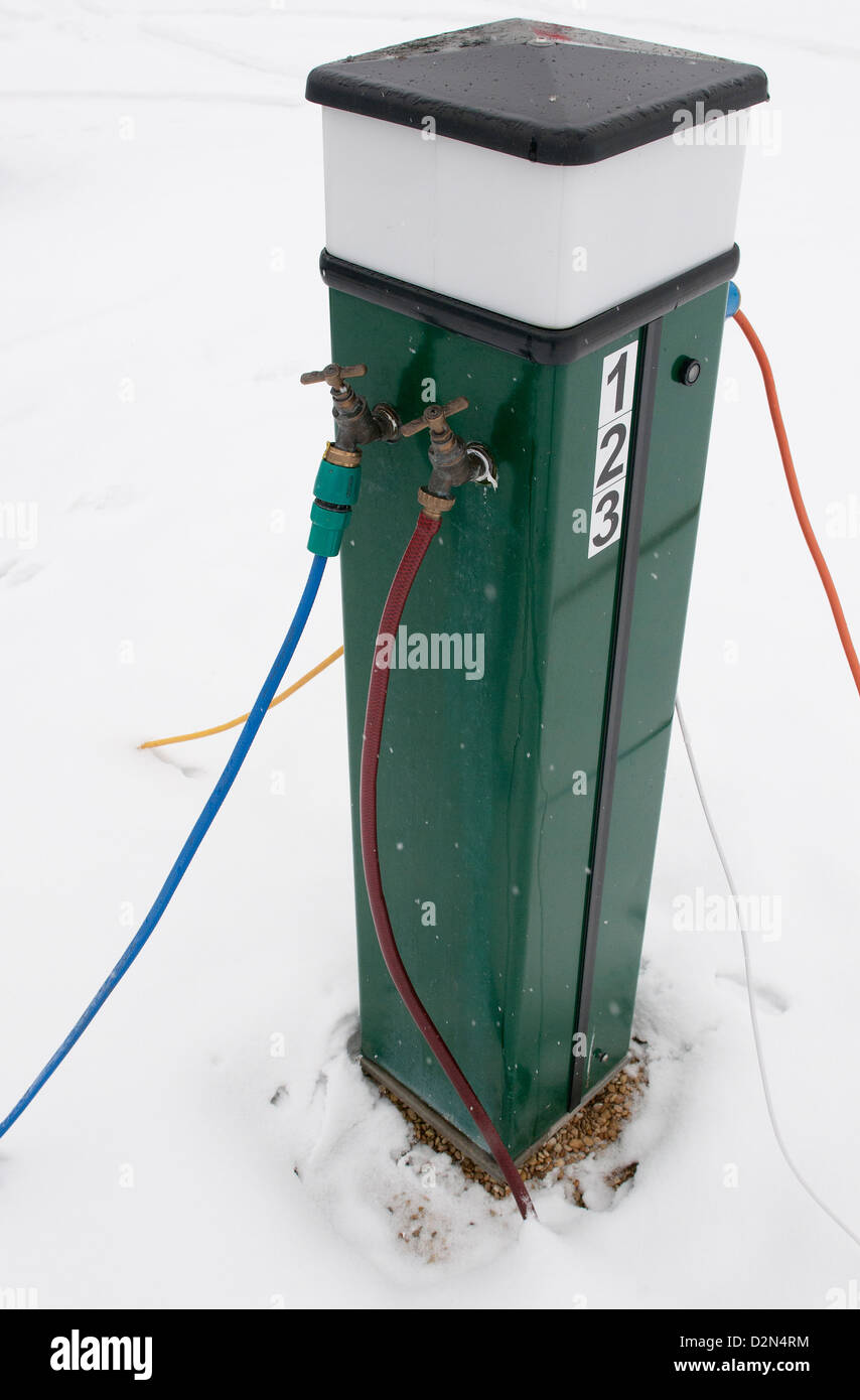 Electric console for supplying 240 volt supply to caravans in an all season caravan park photographed after January snowfall Henley-on-Thames, Oxon,UK Stock Photo