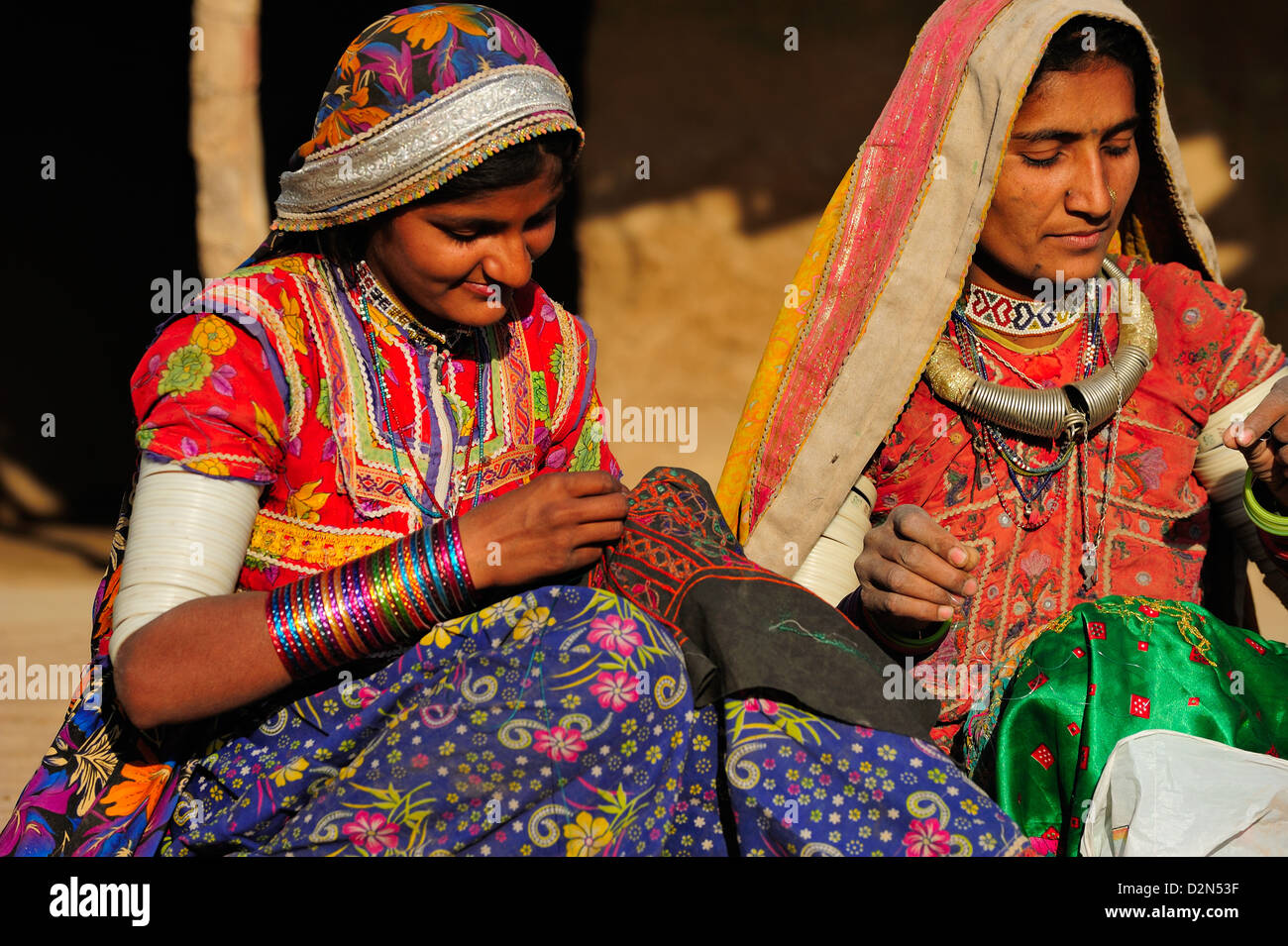 Mir tribal women with traditional attire doing embroidery work, Gujarat, India, Asia Stock Photo