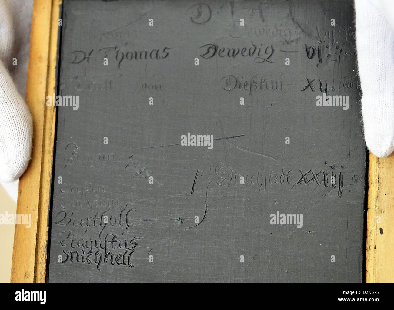 A restored book of wax tablets from the 17th century is presented at