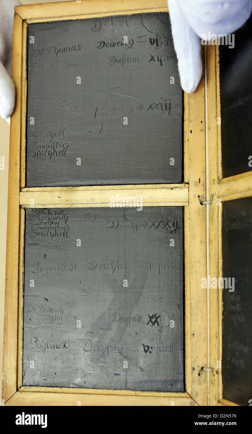 A restored book of wax tablets from the 17th century is presented at