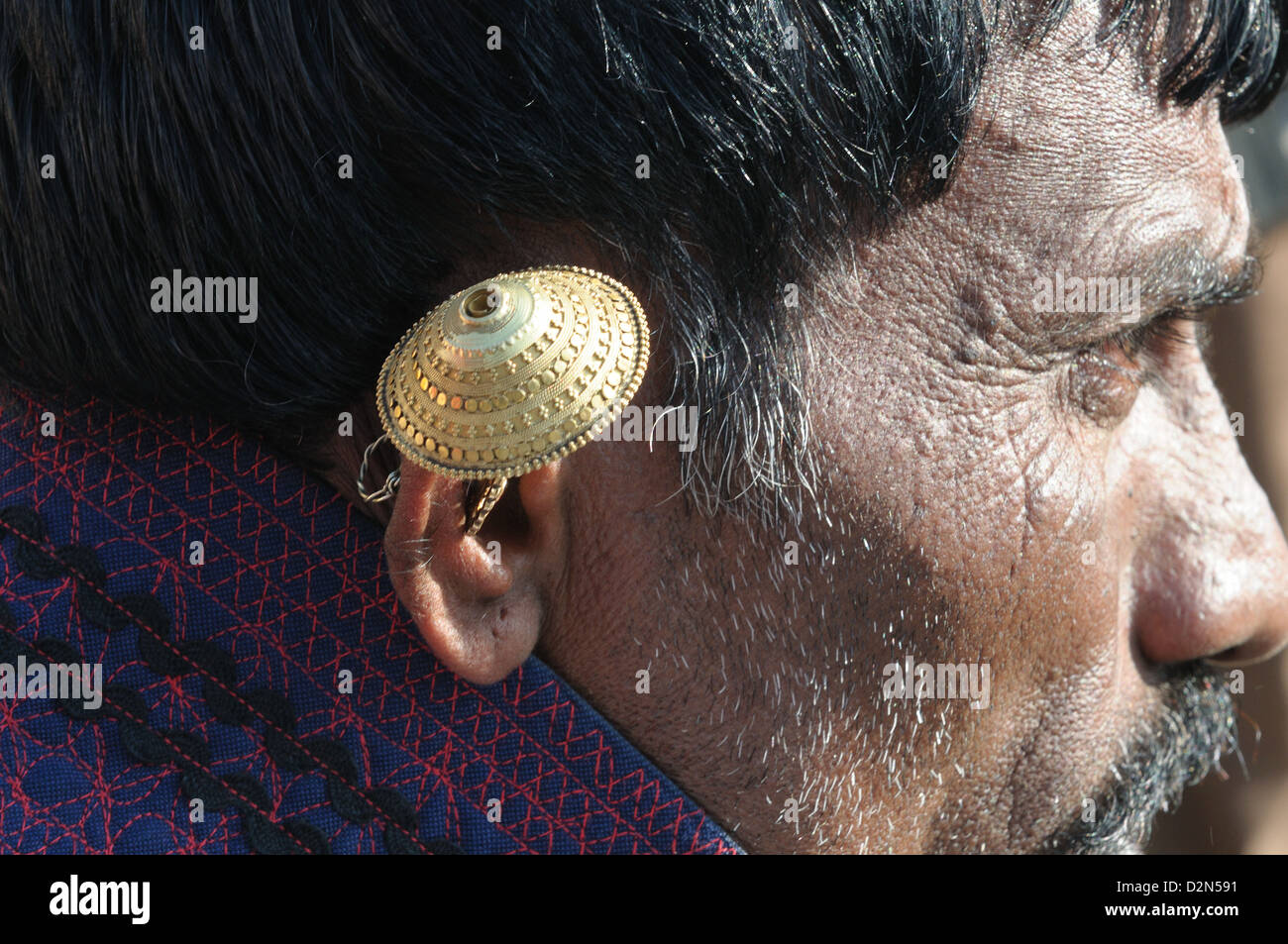 Gold ear ring worn by a Maldhari Gujjar, Gujarat, India, Asia Stock Photo