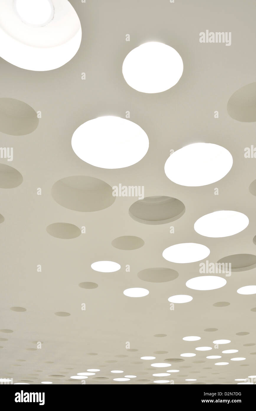 Beautiful and stylish modern design of interior ceiling with bright and round lighting. SOHO Building, Shanghai City, China. Stock Photo