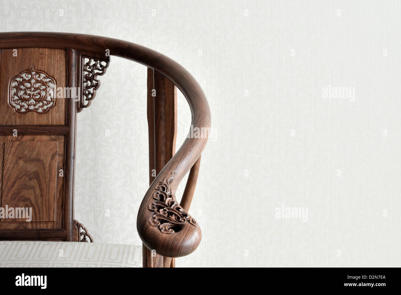 Traditional Chinese wooden chair with decorative flower carving on it. Shanghai, China. Stock Photo