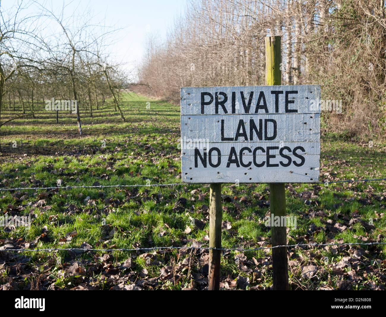 Private land no access sign painted on a board in an English orchard UK Stock Photo
