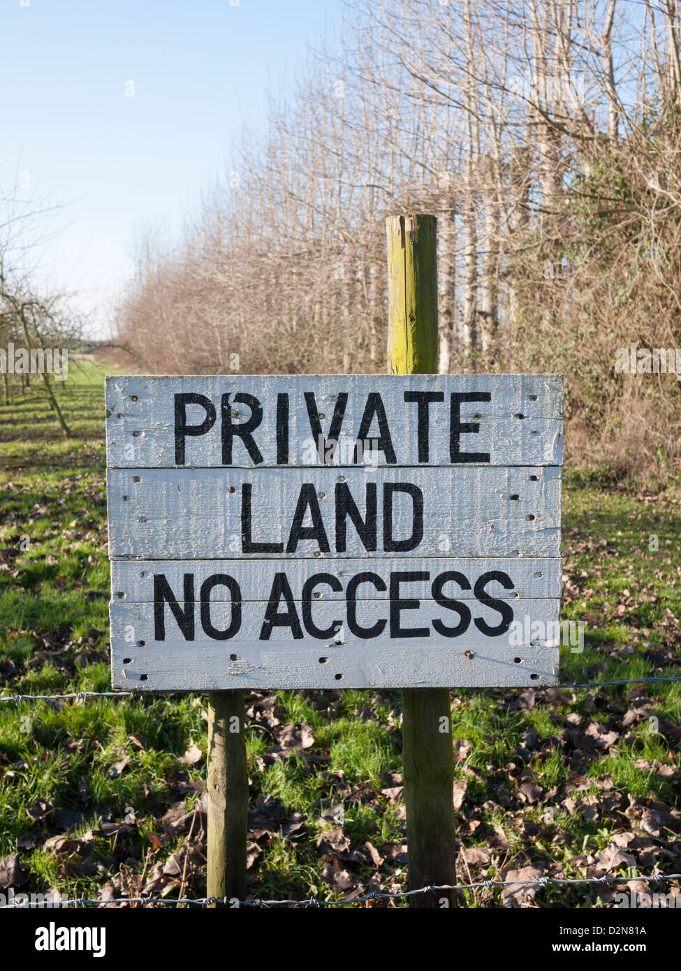 Private land no access sign painted on a board in an English orchard UK Stock Photo