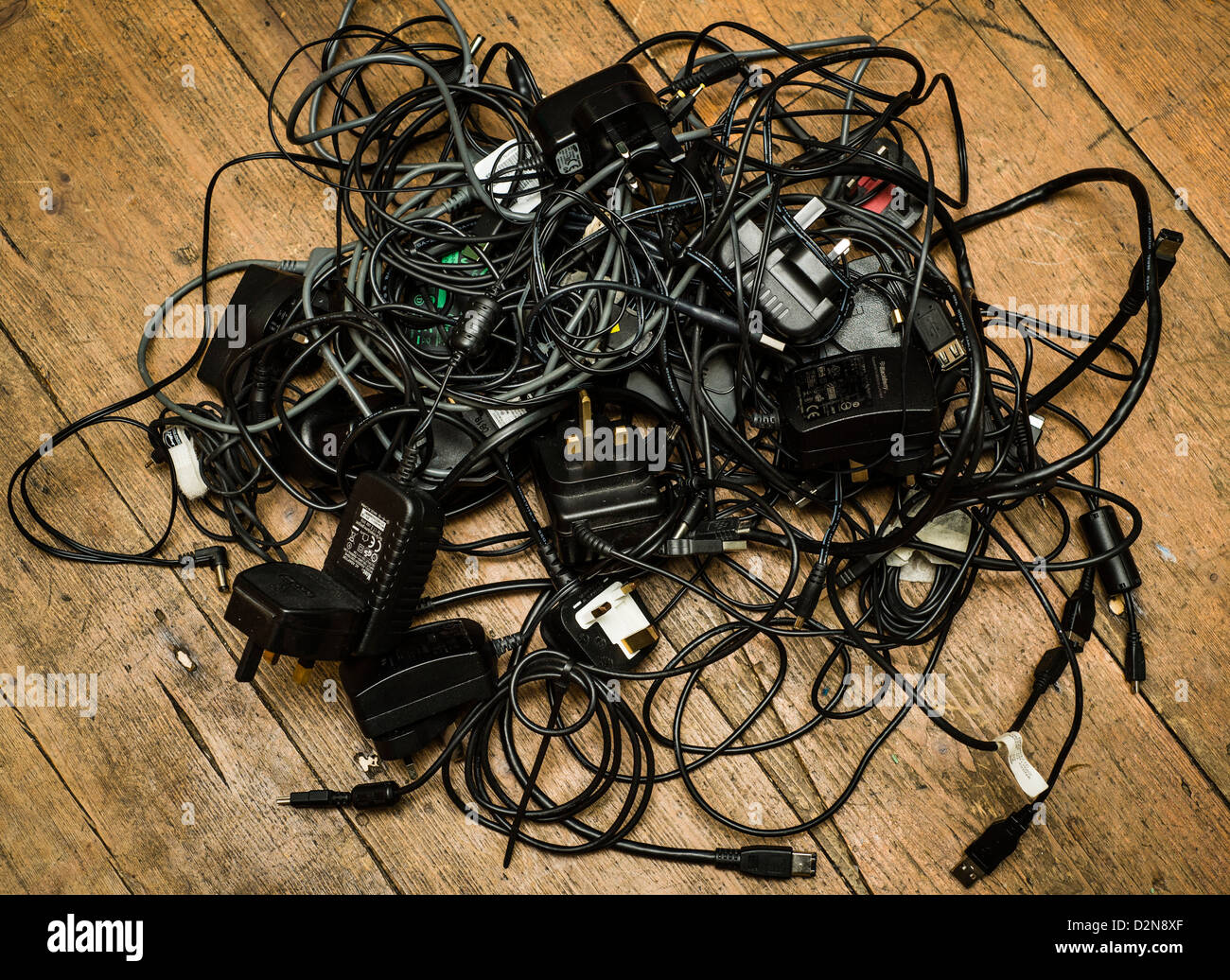 A pile of old redundant mobile phone chargers and other electrical
