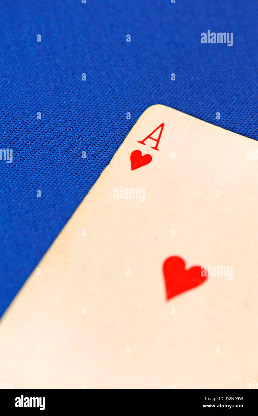 Close-up of an Ace of Hearts playing card on a blue background Stock Photo