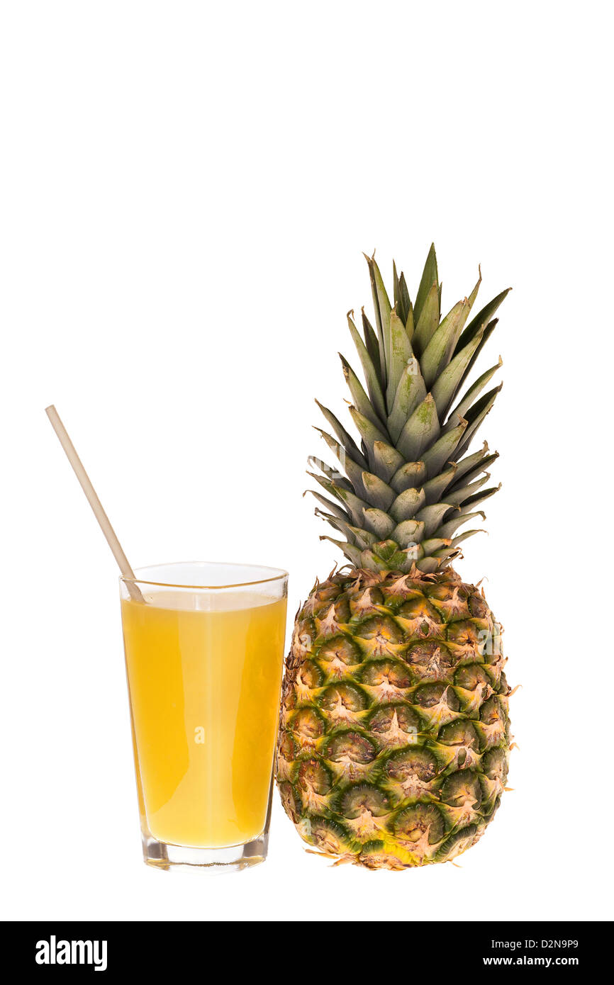 A whole pineapple fruit and a glass of pineapple juice with drinking straw isolated on white background Stock Photo