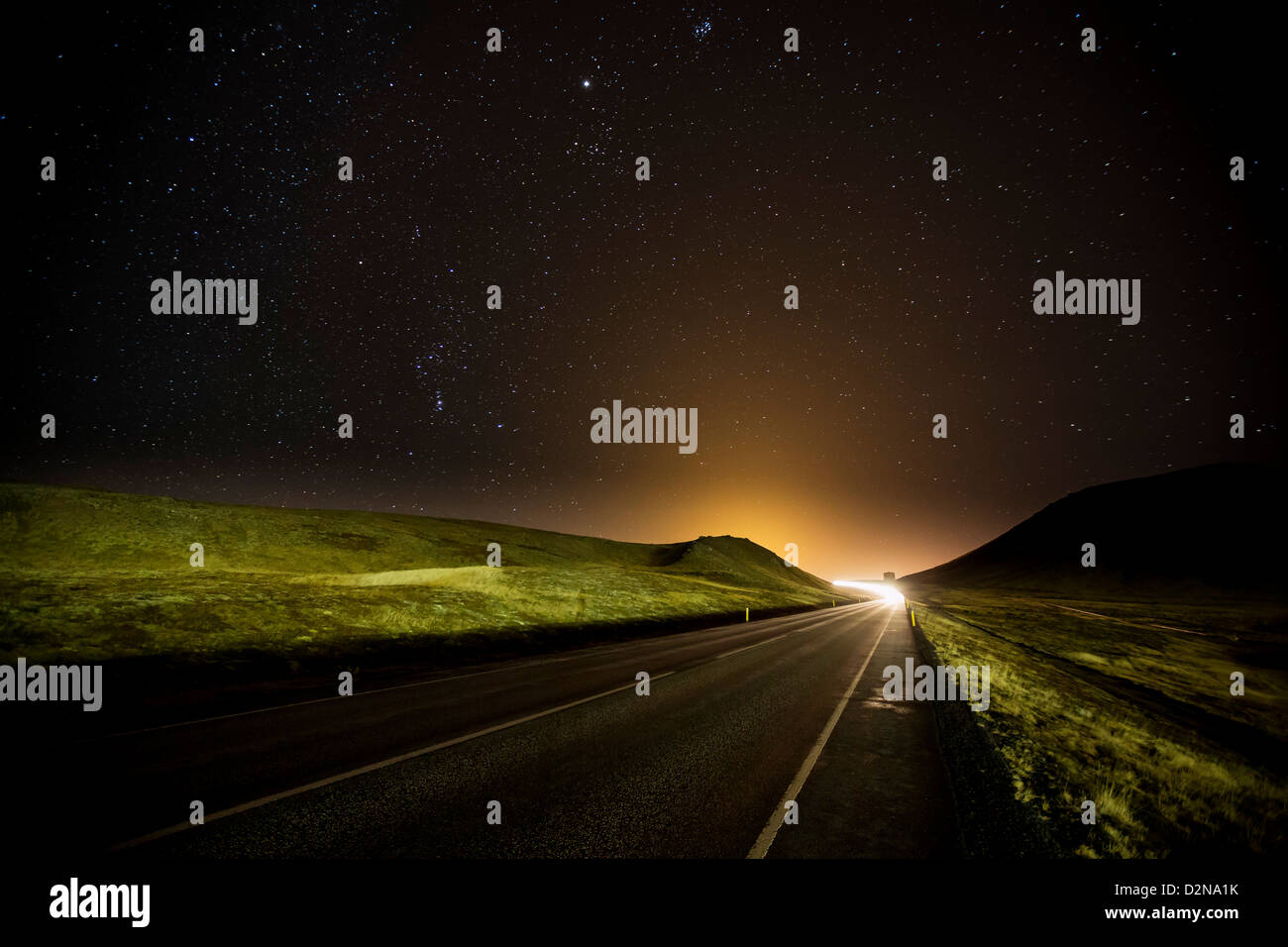 Starry night over road and landscape, Iceland Stock Photo