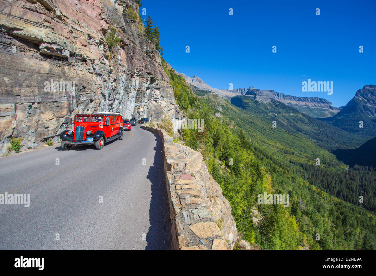 Red Bus on the Going to the Sun Road in Glacier National Park in the Rocky Mountains of Montana Stock Photo