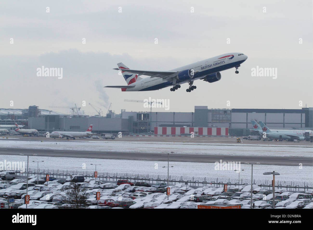 A British Airways commercial jet takes off as Heathrow airport announces delays and cancellations due to bad weather Stock Photo