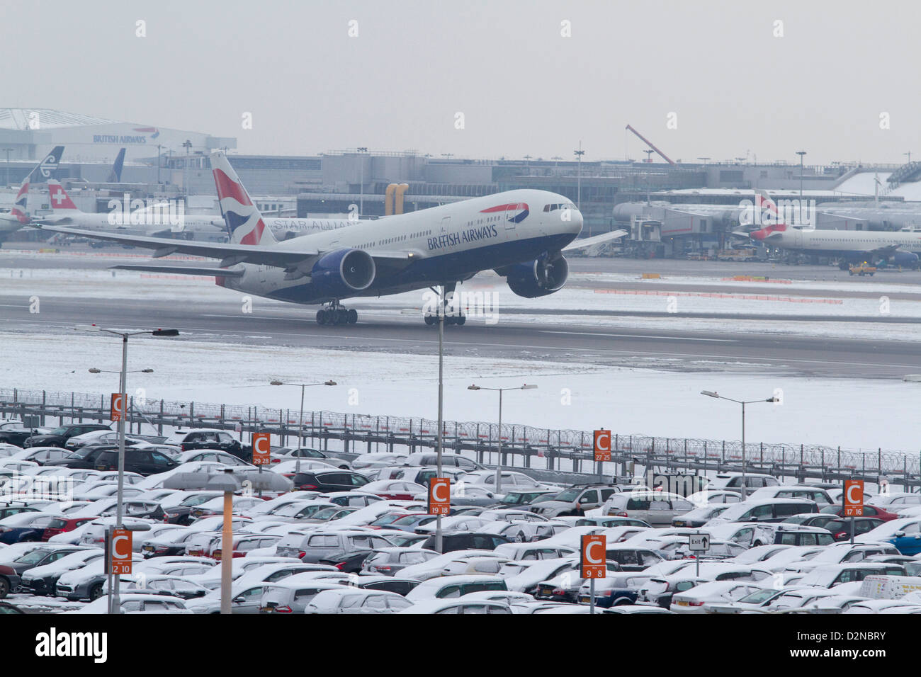 A British Airways commercial jet prepares to take off as Heathrow airport announces delays and cancellations due to bad weather Stock Photo