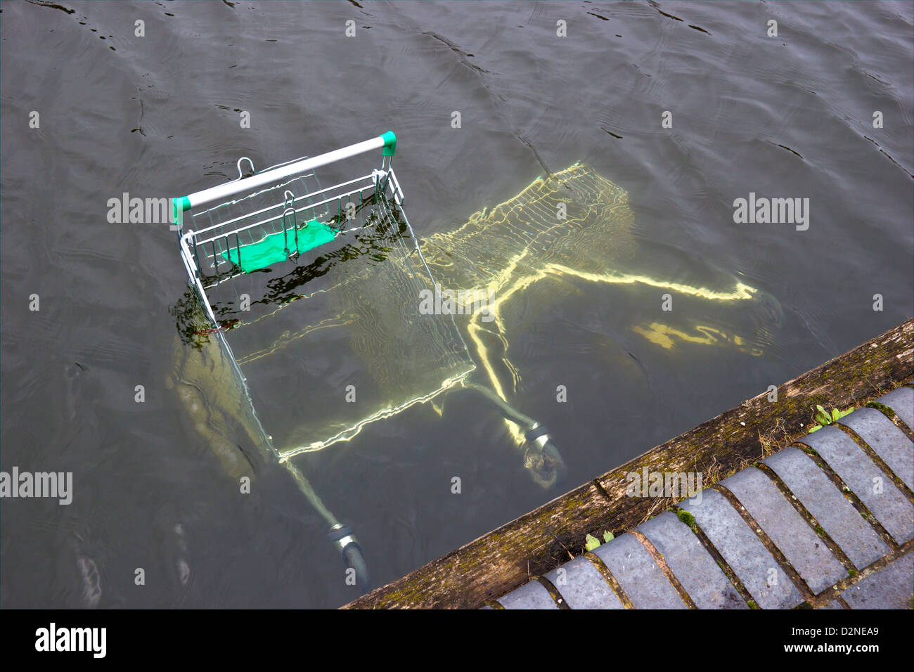 Shopping Trolleys dumped in canal by vandals Stock Photo