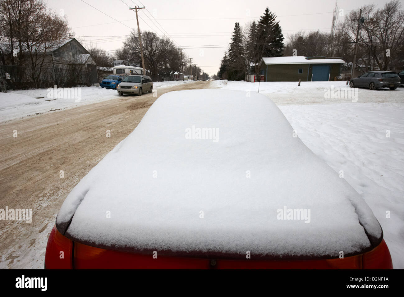 car covered in snow parked by the side of the street pleasant hill Saskatoon Saskatchewan Canada Stock Photo