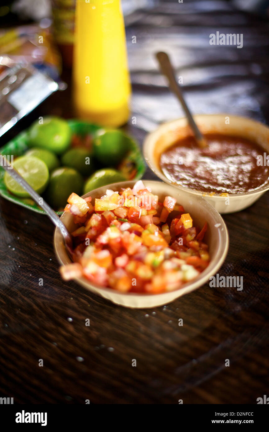Fresh salsas and lime slices complement a meal in Mazatlán, Mexico Stock Photo