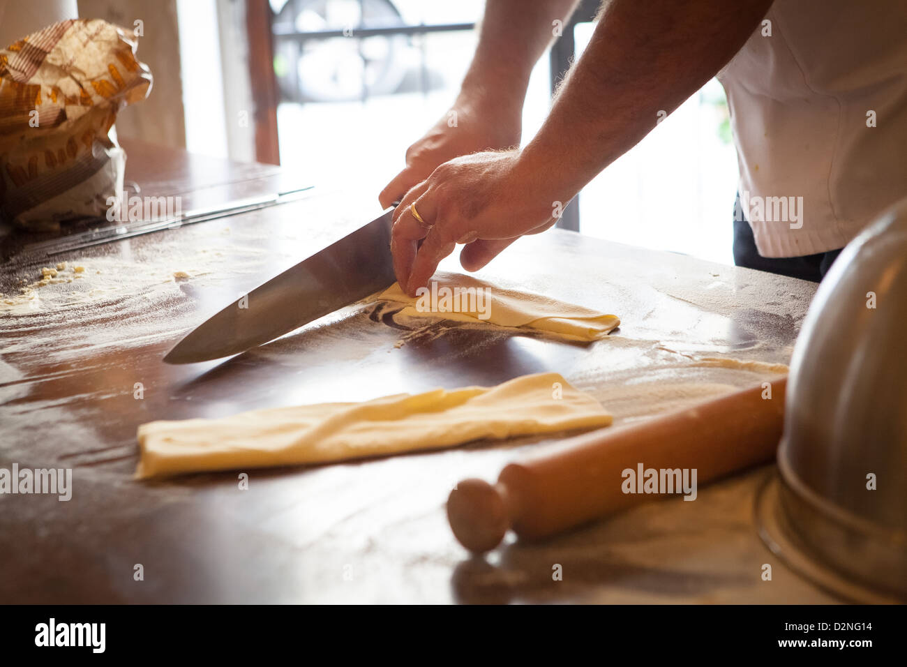 Rolling and cutting Tagliatelle pasta strips Stock Photo