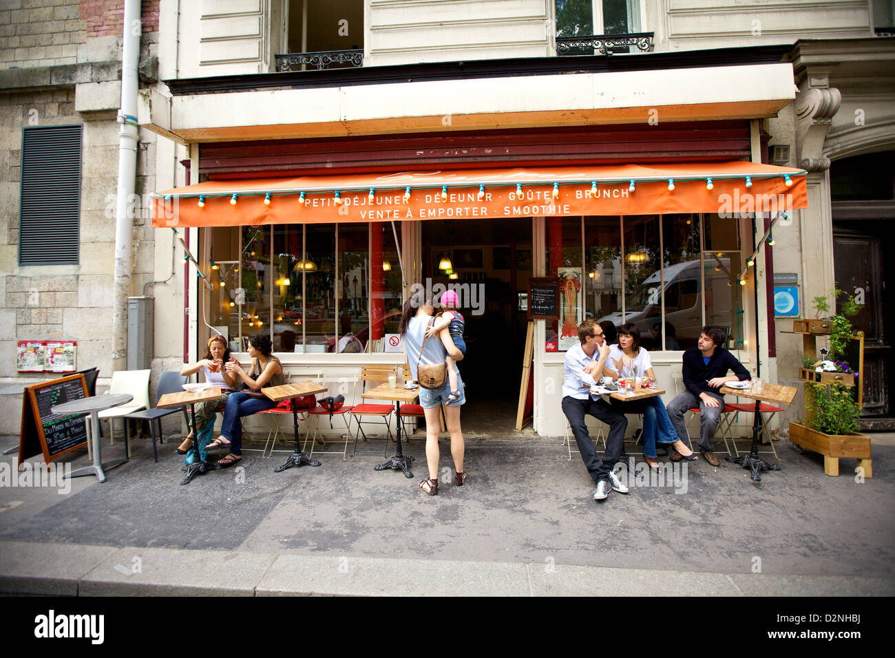 Locals gather at Sesame Cafe along the Canal Saint Martin in Paris, France Stock Photo