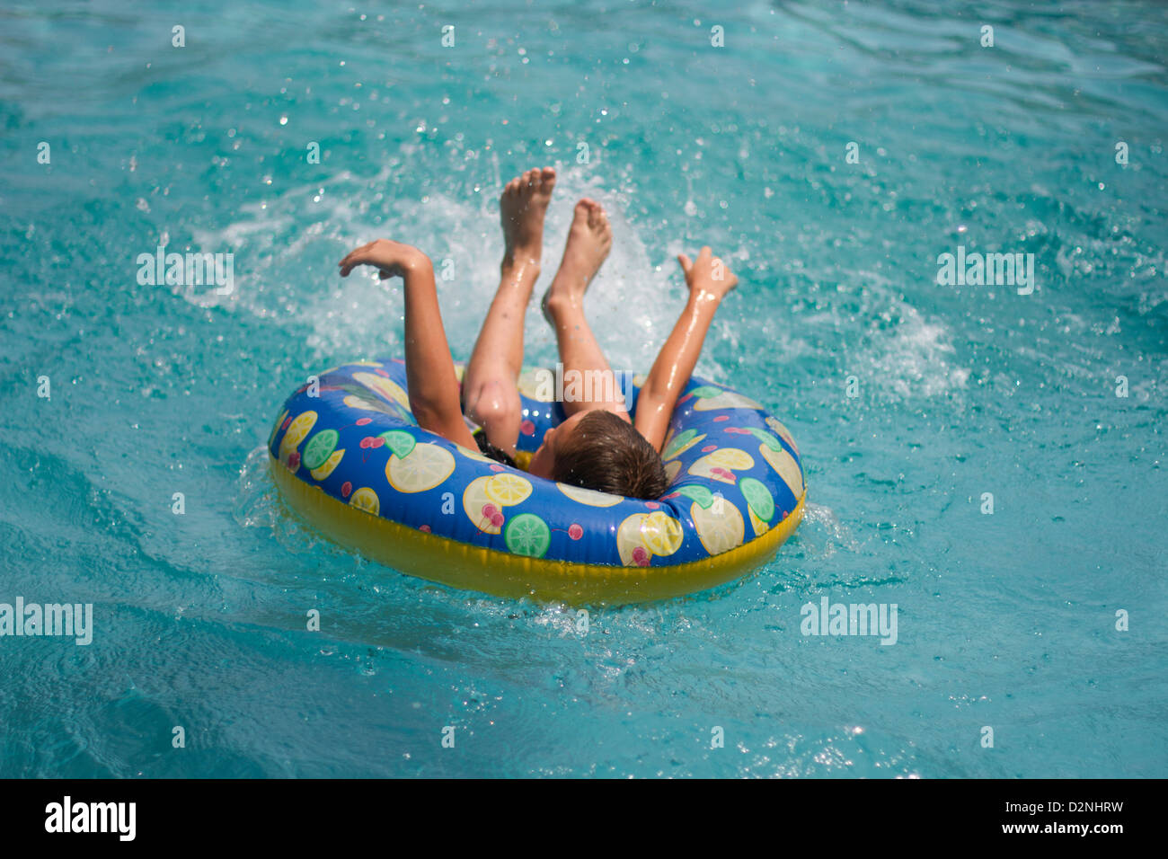 Boy jumping into an inner tube Stock Photo Alamy