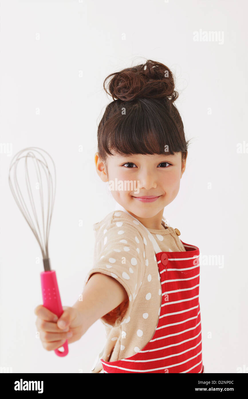 Young girl with apron smiling at camera Stock Photo Alamy